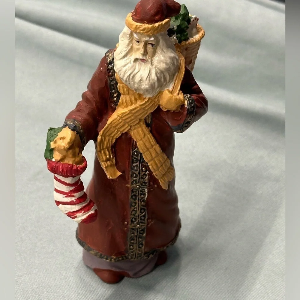 Santa collectible figure in plaster. Santa carries a stocking & basket of treats
